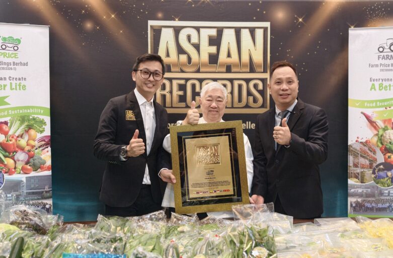 Three men posing on stage with a framed ASEAN Records plaque, thumbs up.
