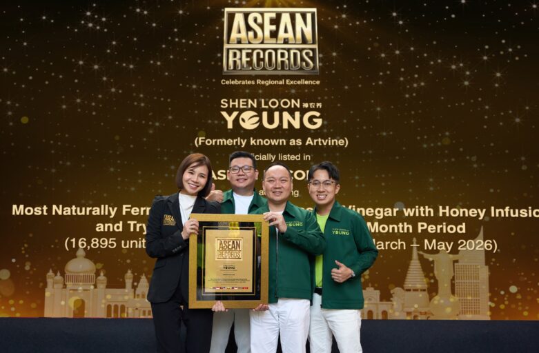 Group of four people on stage holding a framed ASEAN Records plaque with a gold banner backdrop.