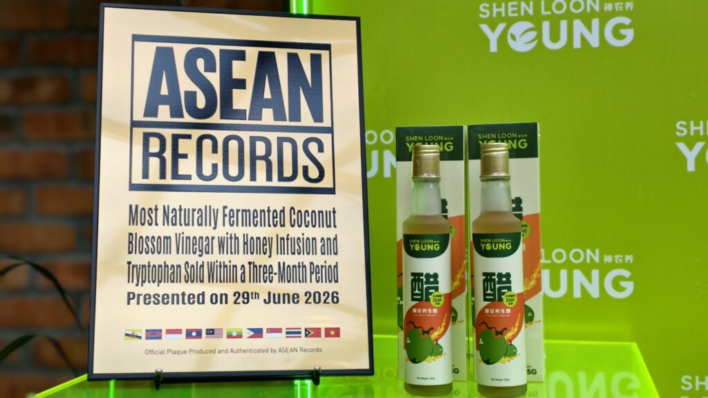 Framed poster reading ASEAN RECORDS beside bottles of coconut vinegar on a bright green background.