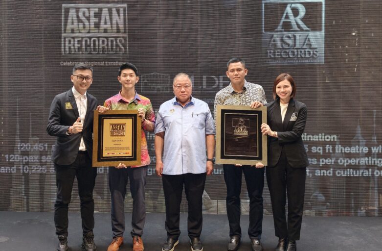 Five people on stage posing with two framed awards; ASEAN Records and AR Asia Records logos visible in the background.