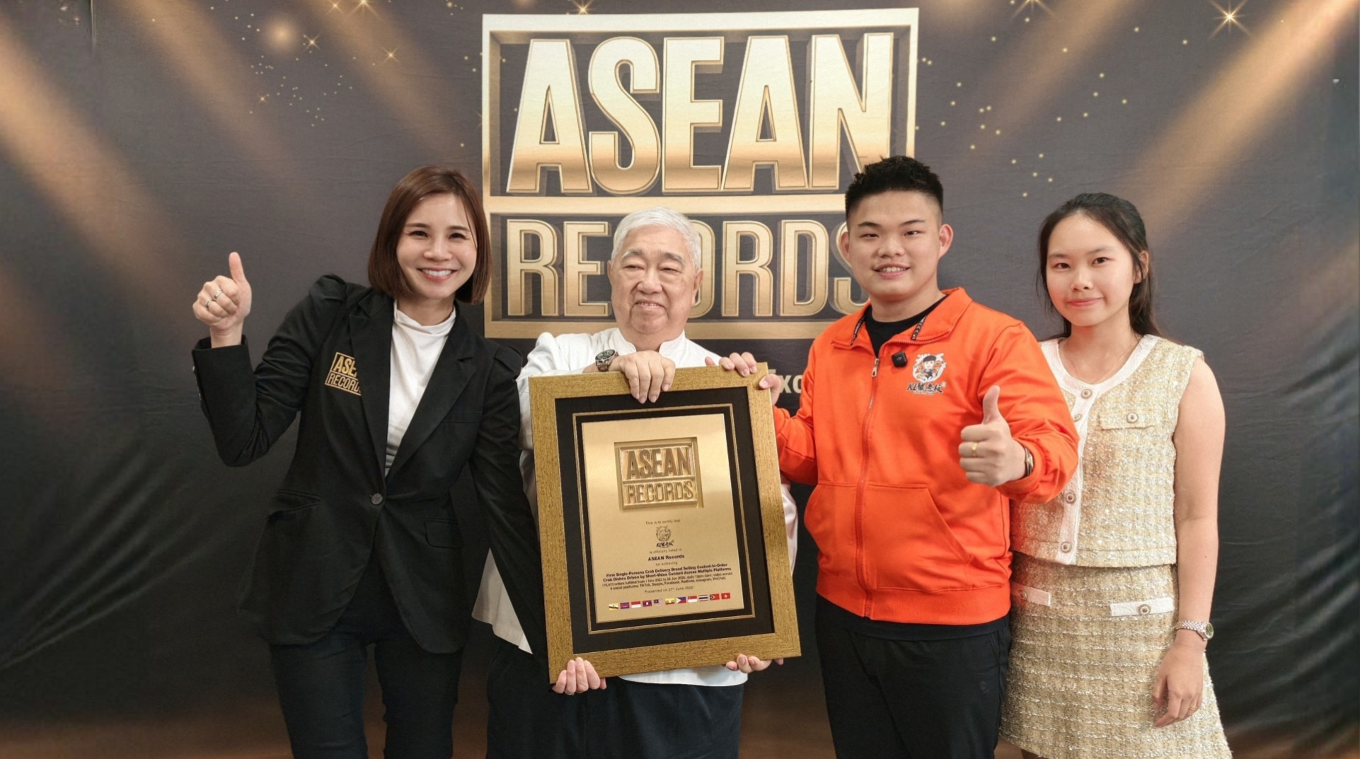 Four people pose together, smiling, holding an ASEAN Records plaque in front of a backdrop that says ASEAN RECORDS.